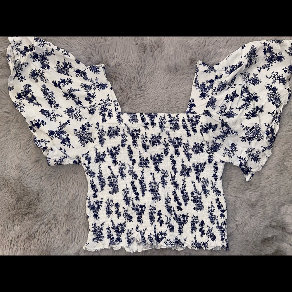 chic blue floral winged blouse.
